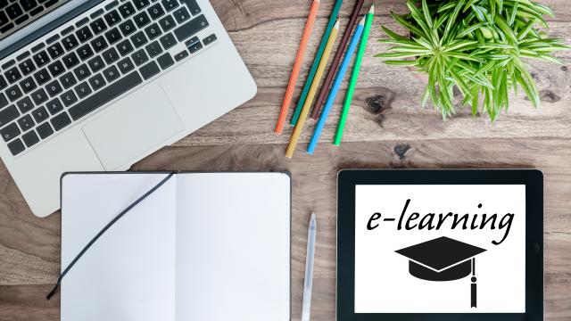 online education e-learning concept with laptop computer, tablet and notepad on wooden desk