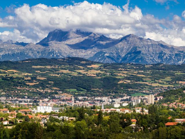 The city of Gap in the Hautes Alpes with surrounding mountains and peaks in Summer. Panoramic. Southern French Alps, France