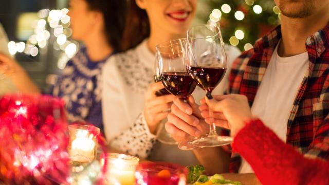 close up of friends with wine celebrate christmas