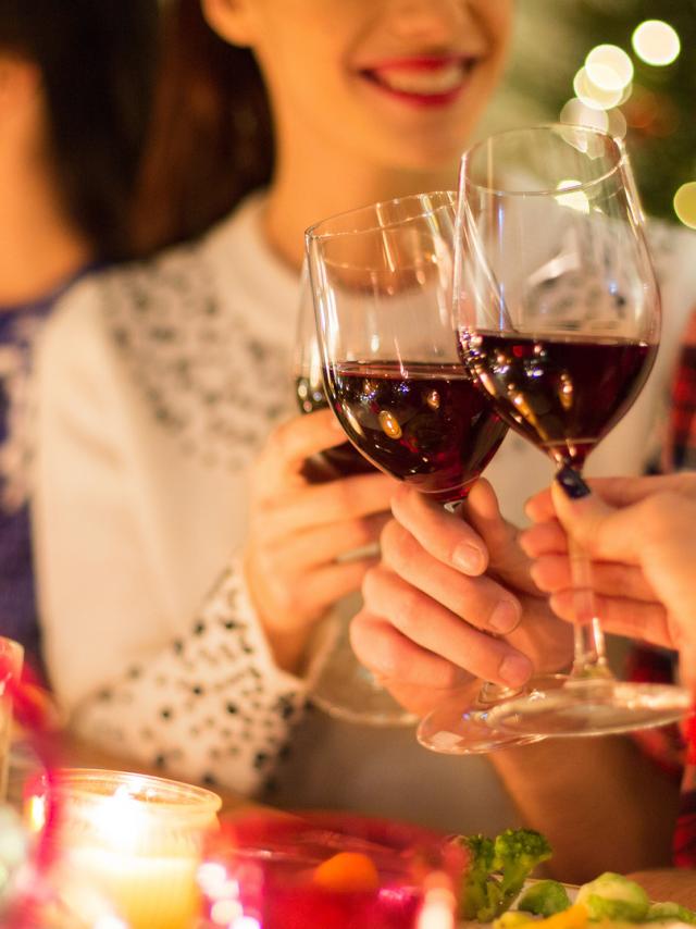 close up of friends with wine celebrate christmas