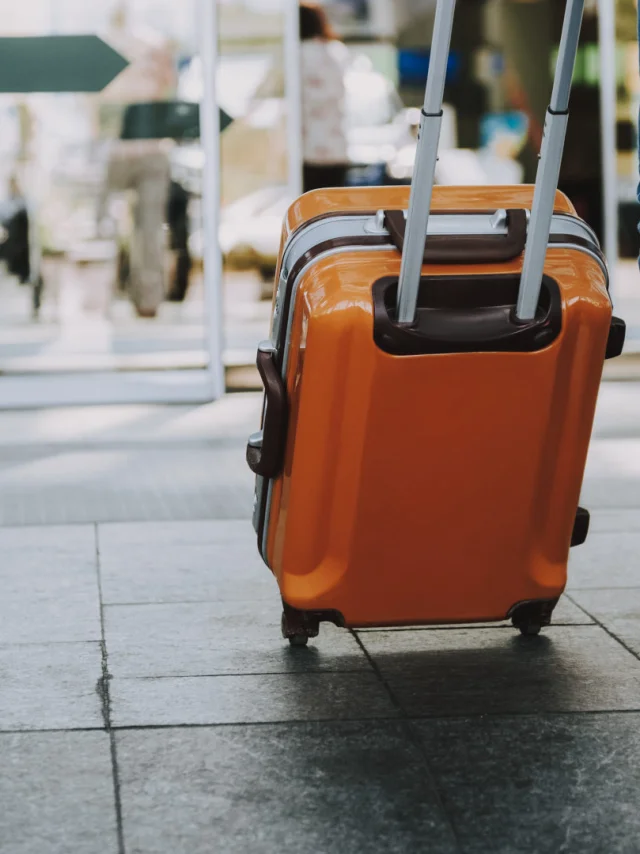 Close-up of man walking with suitcase. He is going in departure lounge. Copy space in left side