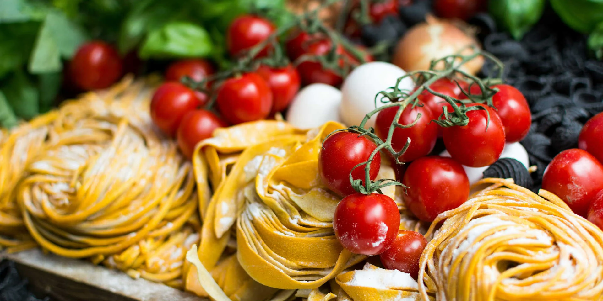 Close-up of fresh tagliatelle and cherry tomatoes