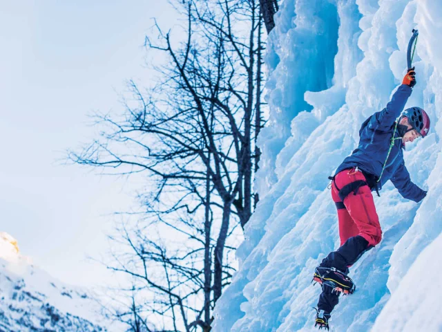 Man climbing an icefall in Pelvoux