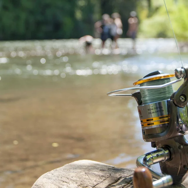Fishing reel and lake in background