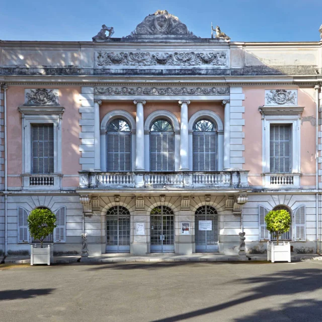 La grande façade rose et blanche du palais Carnolès