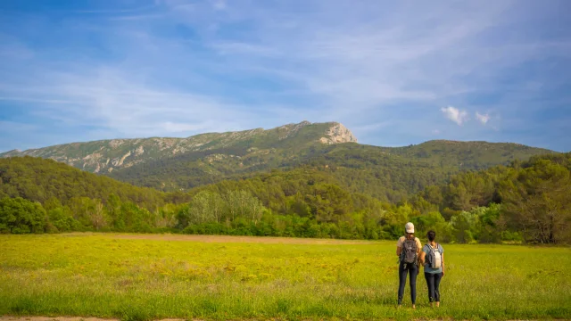 Deux randonneuses de dos qui admirent le massif de la Sainte-Victoire