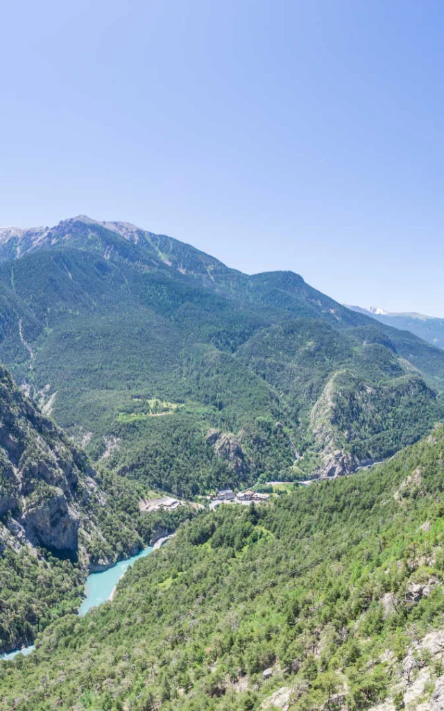 A climber in the Southern Alps above a stunning panorama