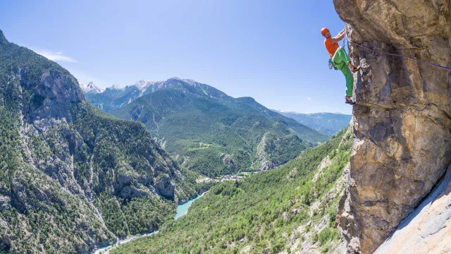 A climber in the Southern Alps above a stunning panorama