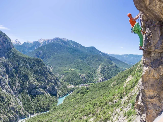 A climber in the Southern Alps above a stunning panorama