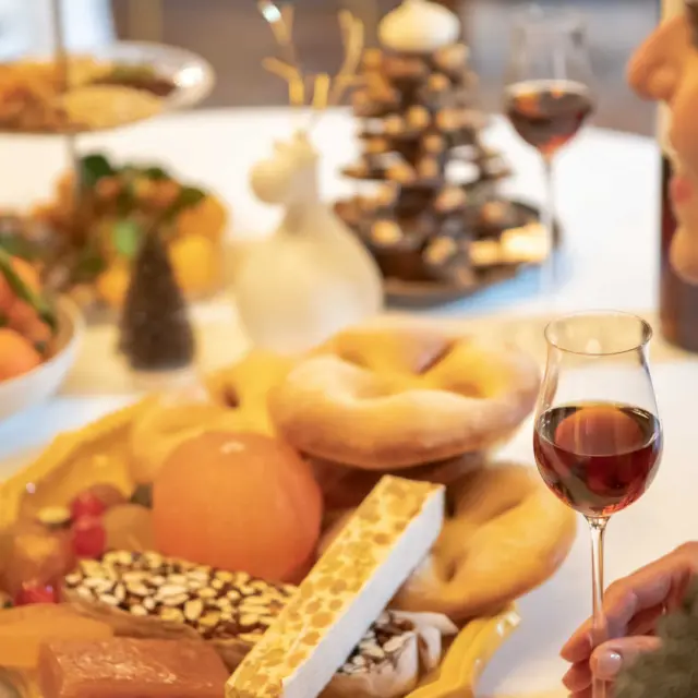 Woman seated at a table in front of a Christmas meal